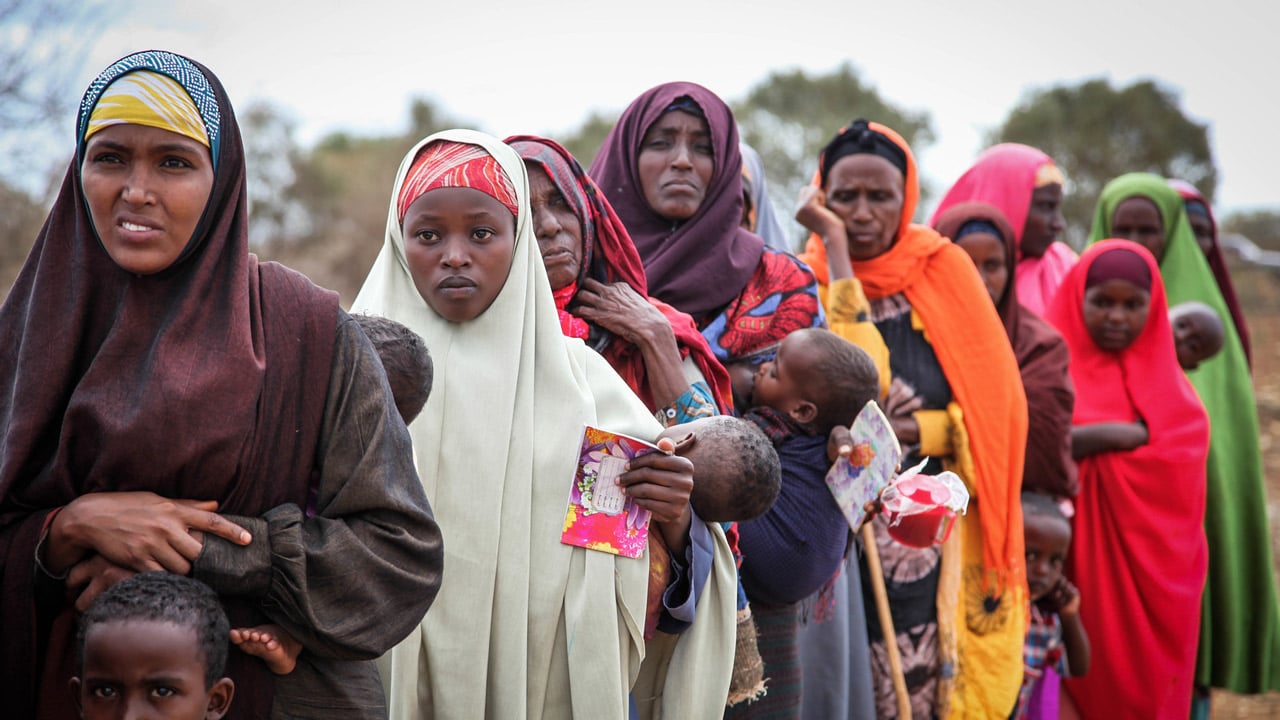 Women and children queue to enter a free medical clinic treating various diseases including STIs, Somalia.