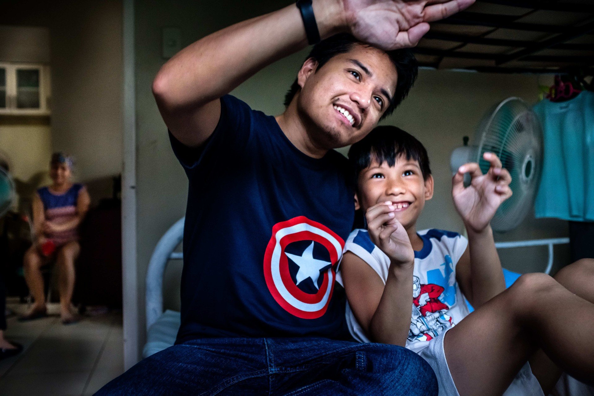 Vhal plays with his 8-year old son, Raigel Haythan, in their home in Mandaluyong